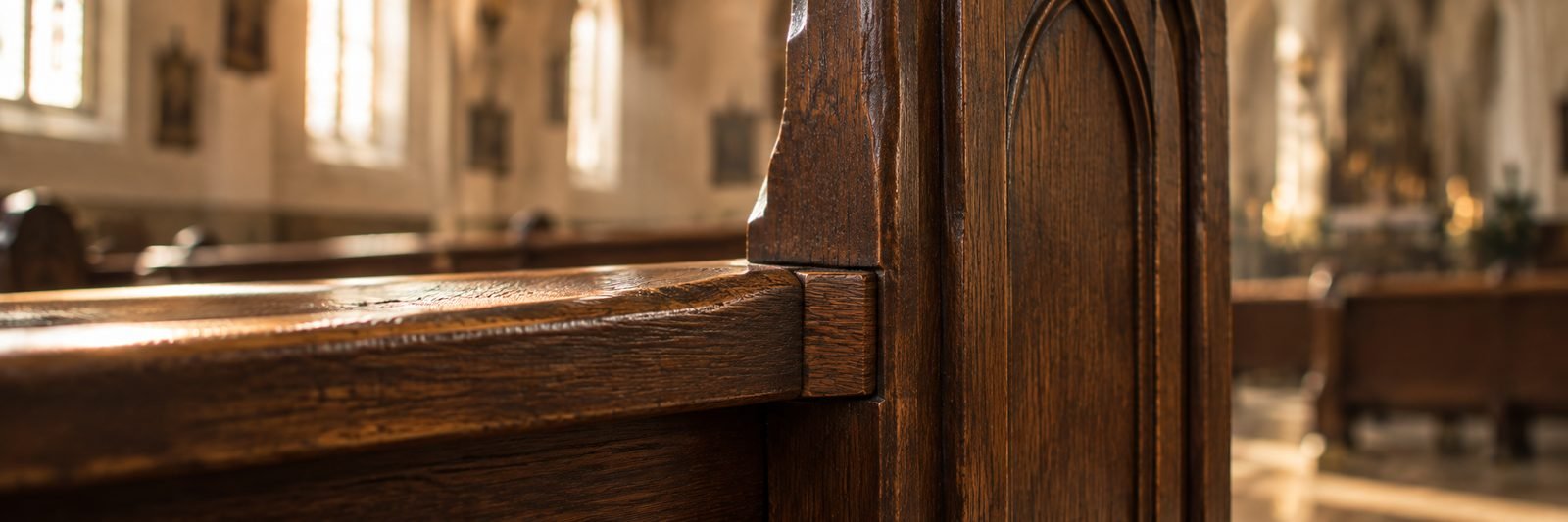 Oak pew seat meeting the pew end at a tight joint