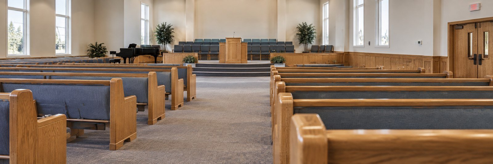 Modern church sanctuary with oak pews, labeled by the work Bethel Finish Works does on each part of the room
